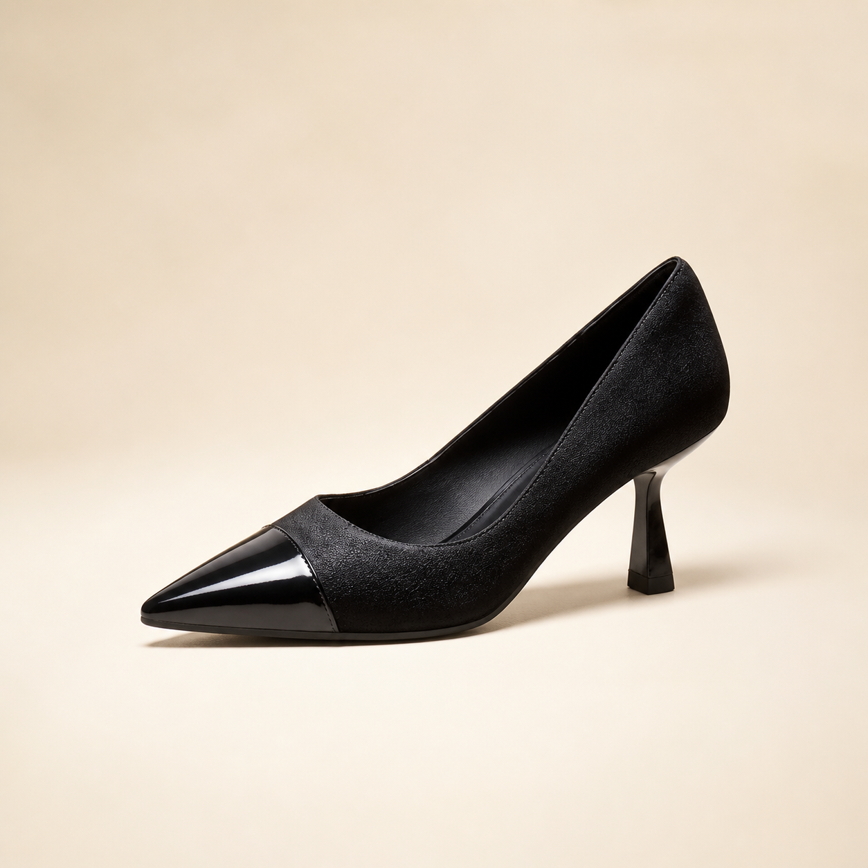 Black two-tone pointed-toe pump with glossy toe cap and sculpted flared heel